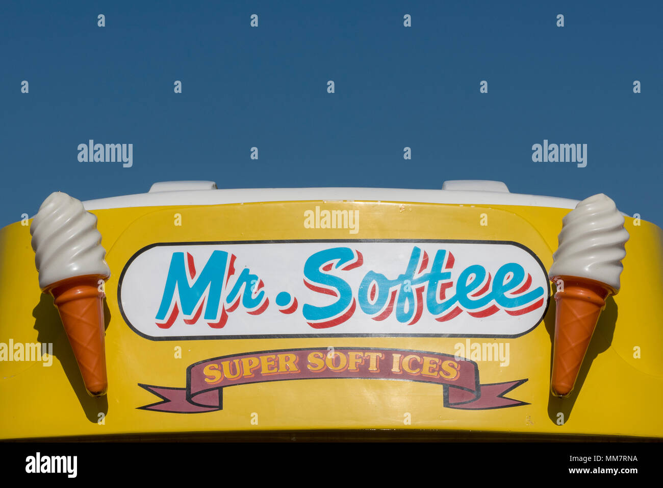 the logo or sign on the top of an ice cream van with mr softee or softie written on the illuminated pnel on front. name badge on ice cream van seaside Stock Photo