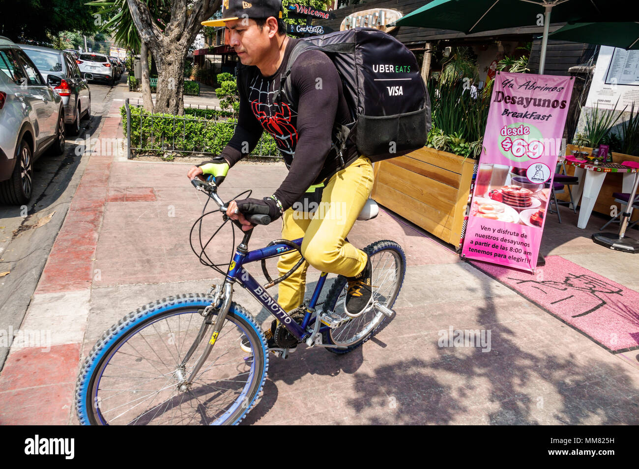 Mexico City,Polanco,Hispanic,immigrant immigrants,Mexican,man men male,delivery boy,Uber Eats,bicycle bicycles bicycling riding biking rider riders bi Stock Photo
