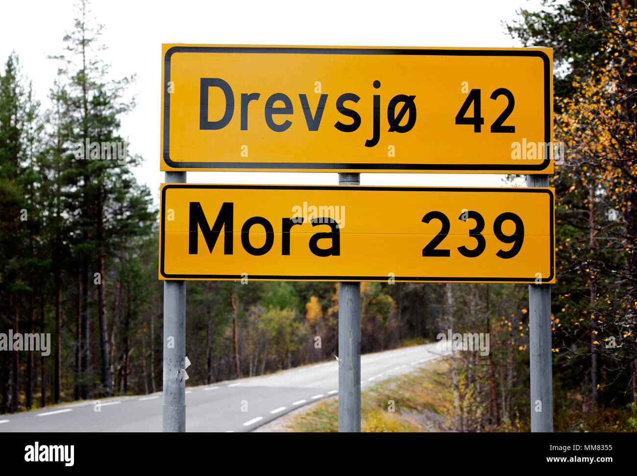 Distance in km to the Norwegian village Drevsjo and the Swedish town Mora on a Norwegian distance indication road rign. Stock Photo