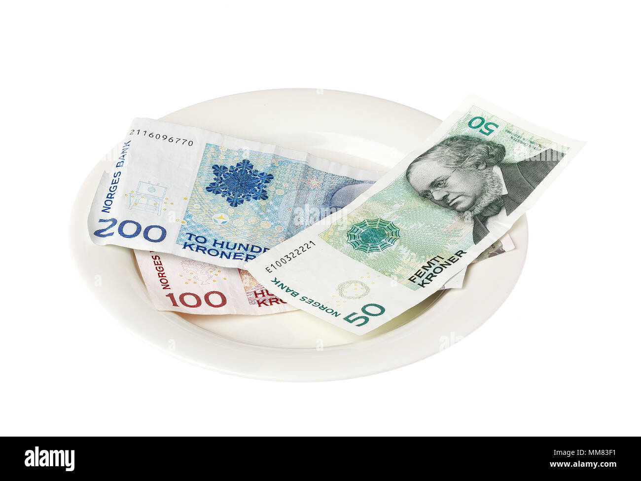 Norwegian banknotes on a small plate isolated on white background. Stock Photo