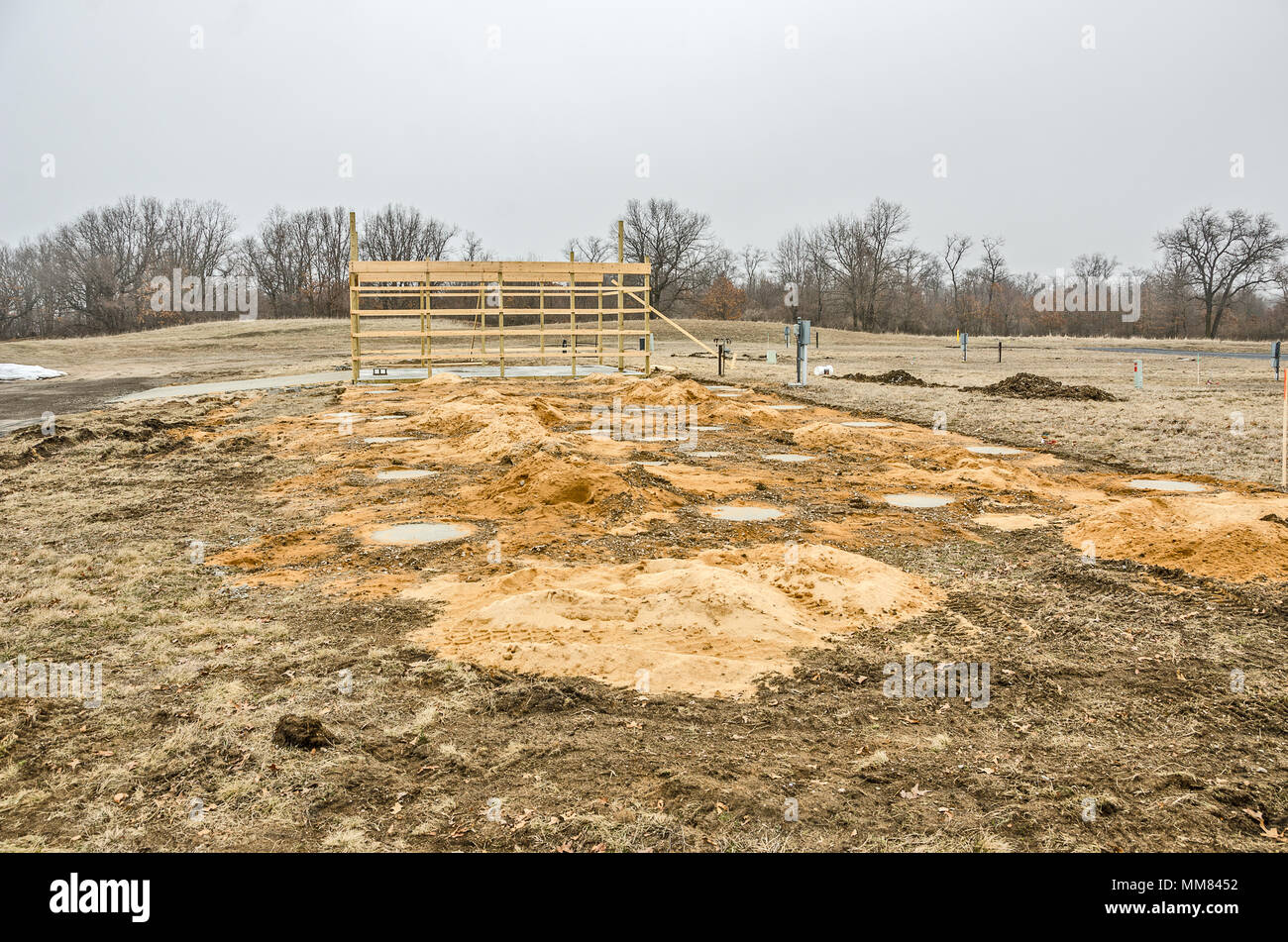 Framing for a garage with concrete floor and driveway. Concrete
