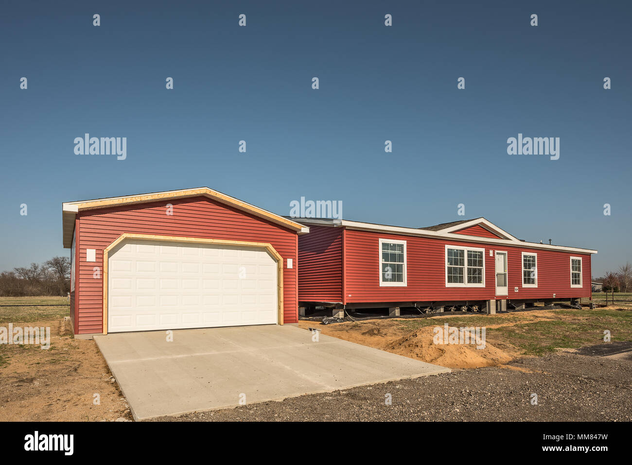 New manufactured home and stick built garage need finishing before owners can move in Stock Photo
