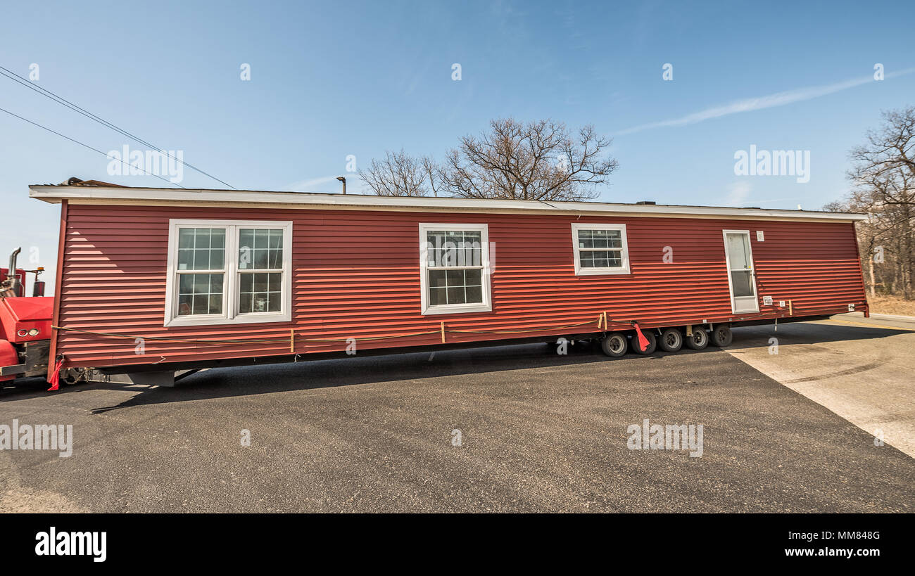 Half of new manufactured home arriving at it's destination Stock Photo