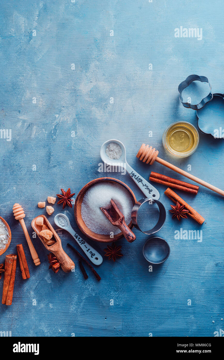 Kitchen utensils for baking, flour, sugar, whisks, cookie cutters and a