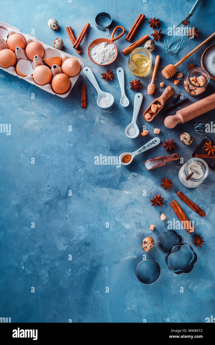 Cooking tools and ingredients from above. Baking concept with measuring  spoons, wooden scoops, whisks, cookie cutters, sugar, flour, eggs and  cinnamon Stock Photo - Alamy