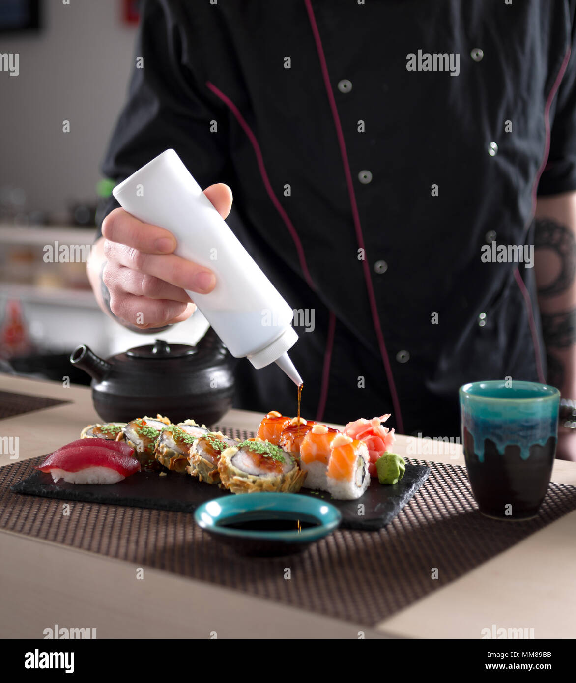 Preparing sushi rolls in Jaopanese restaurant. Stock Photo