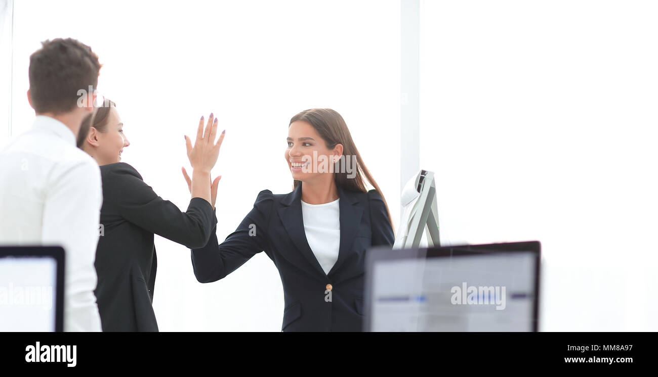 employees giving each other high five Stock Photo - Alamy