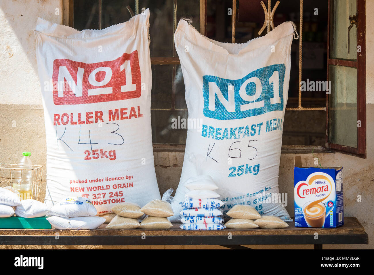 Two large bags containing nonperishable food sit on top of table with