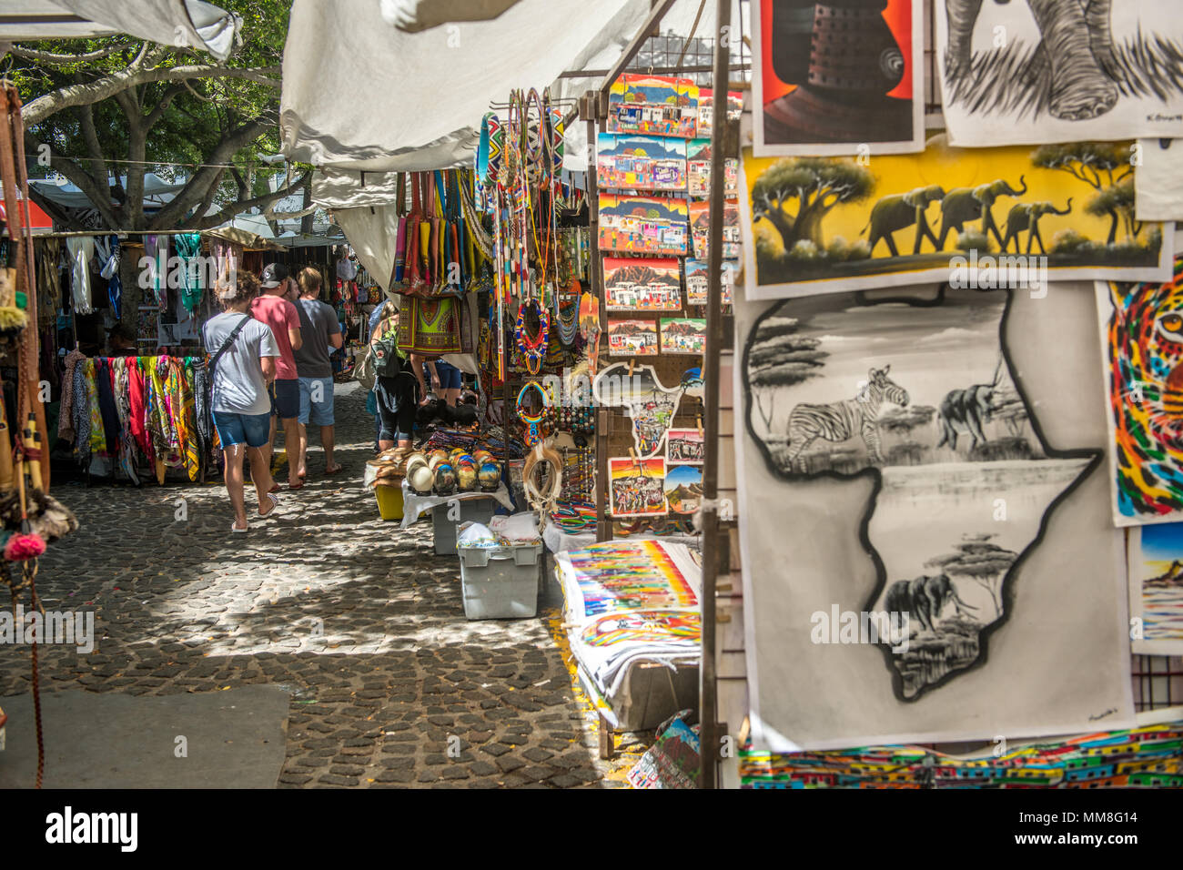 Tourists walking among the handcrafted artwork and other souvenirs that