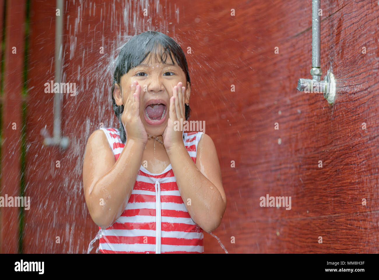 Happy little girl taking shower before swimming, healthy and recreation