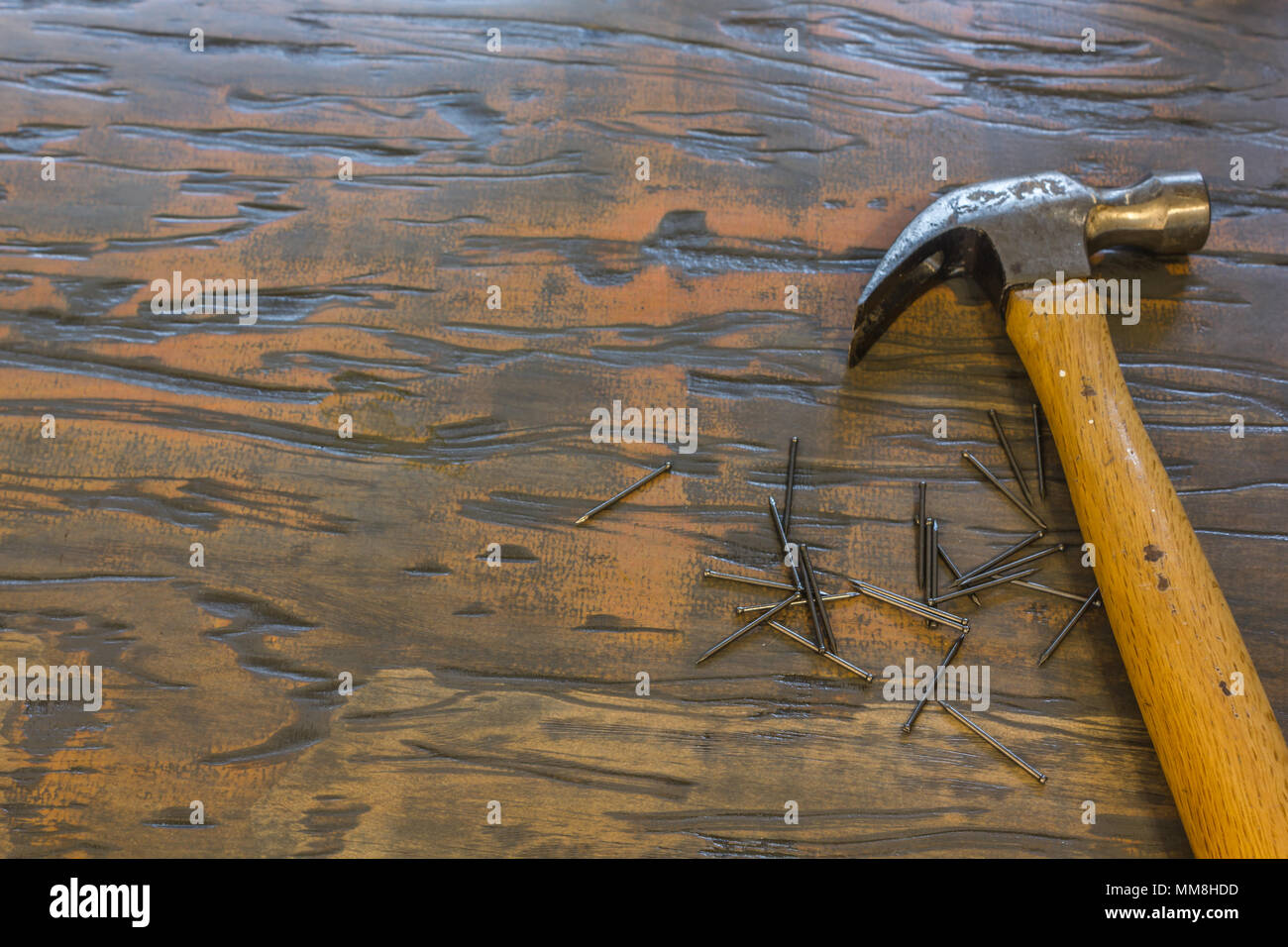 Hammer and nails on wood table Stock Photo