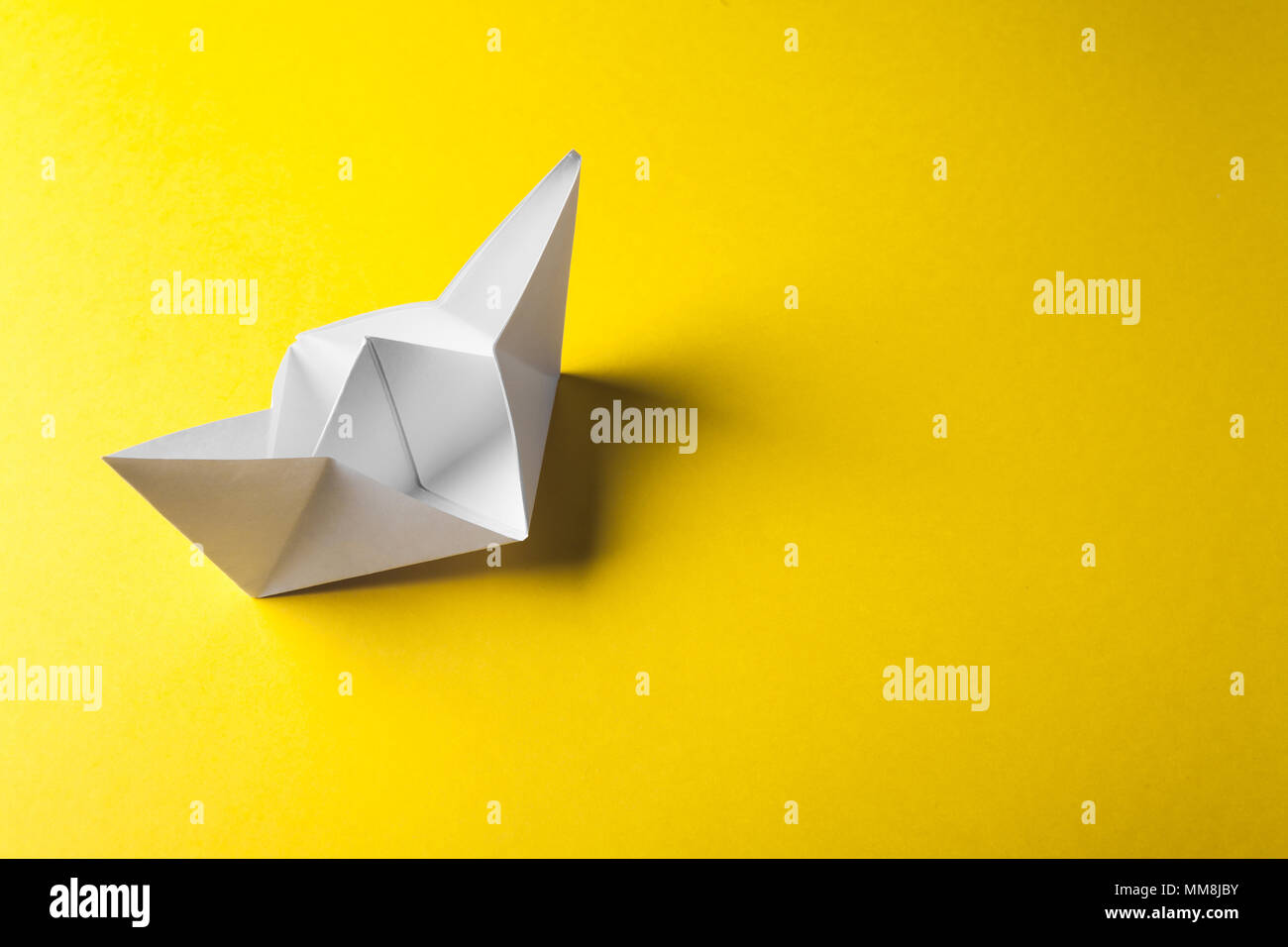 boat paper origami on the yellow background Stock Photo