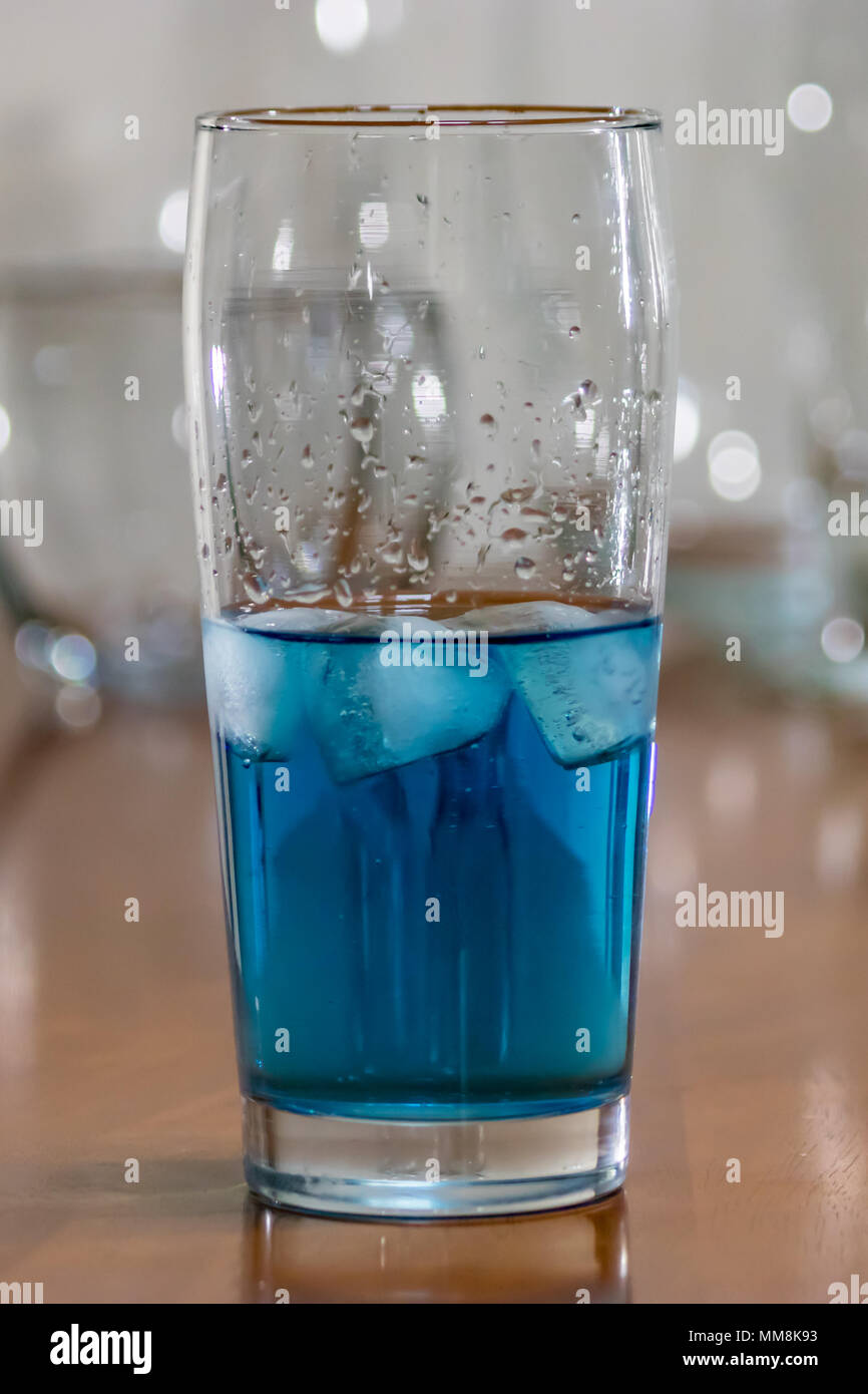 close up of blue water glass on table Stock Photo
