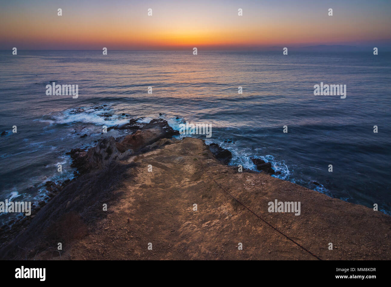 Longexposure shot looking down a steep hiking trail at smooth waves