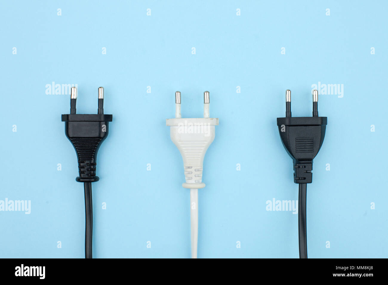 Trendy flat lay minimal concept, unplugged cord on blue background Stock Photo