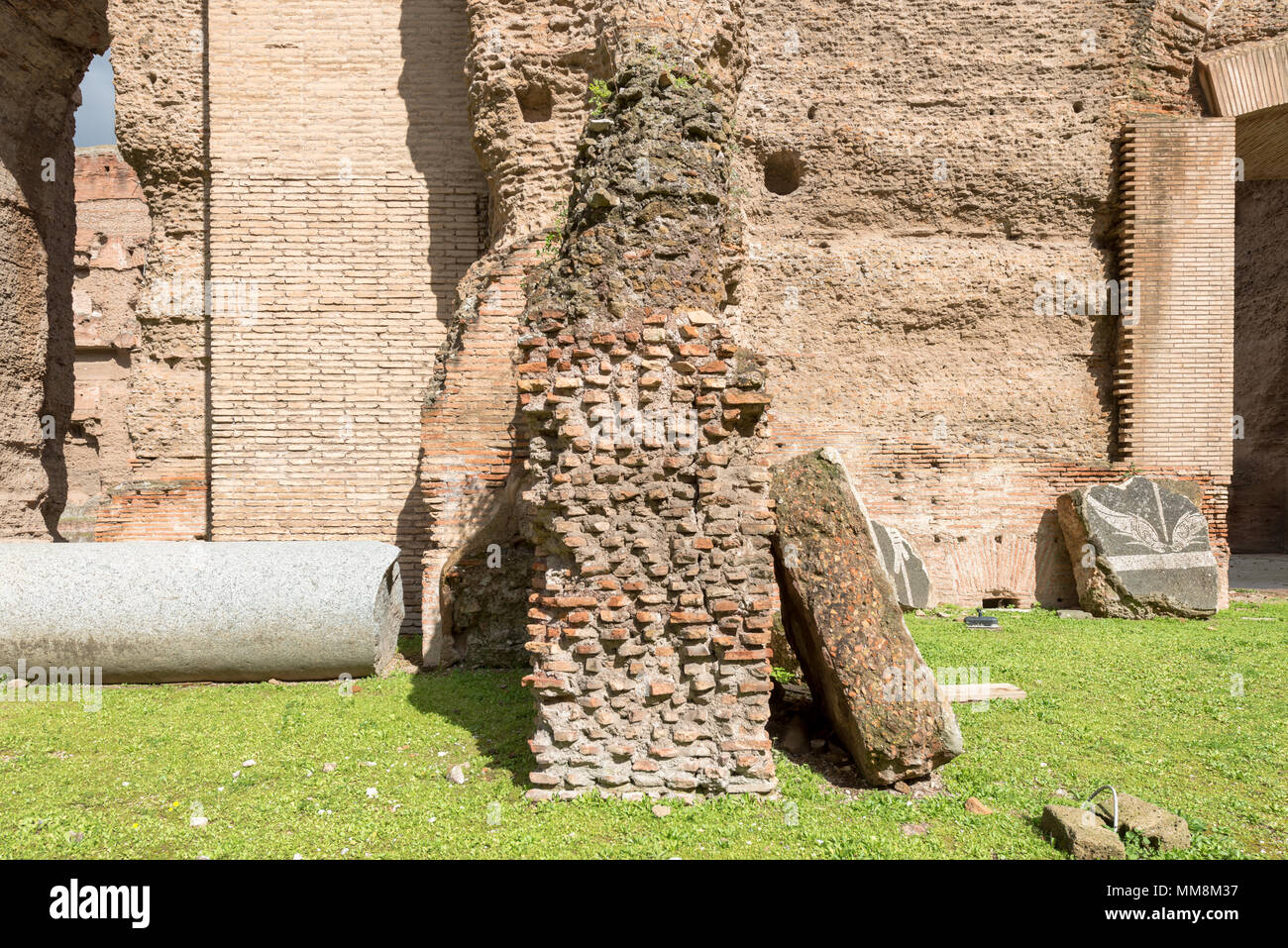 Front picture of green grass with old buildings of Baths of Caracalla