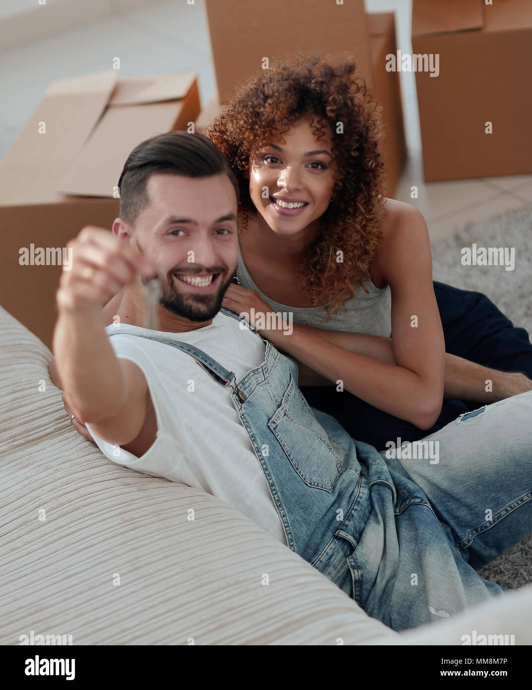 young couple holding the key to a new apartment Stock Photo - Alamy