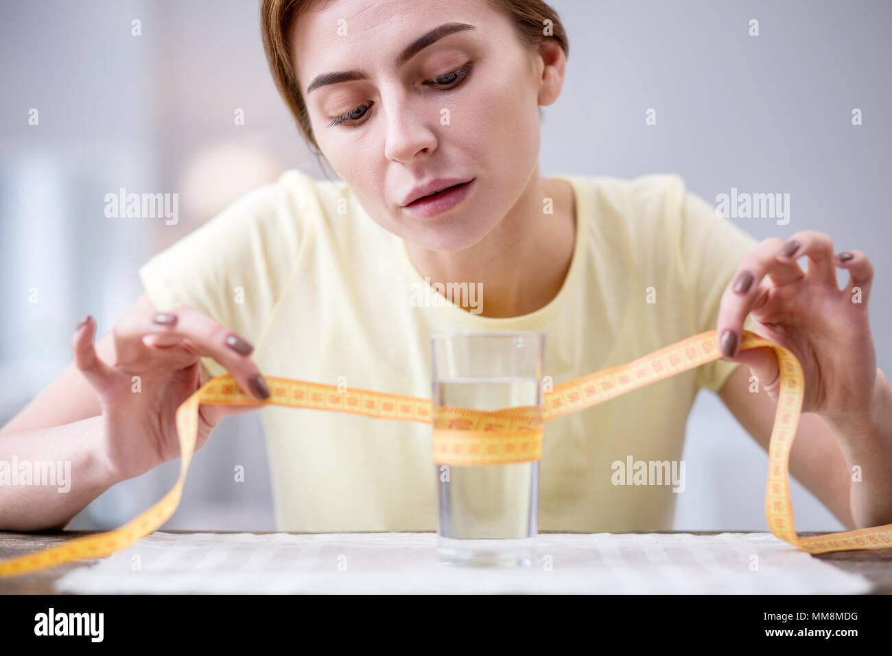 Nice serious woman holing a centimeter tape Stock Photo