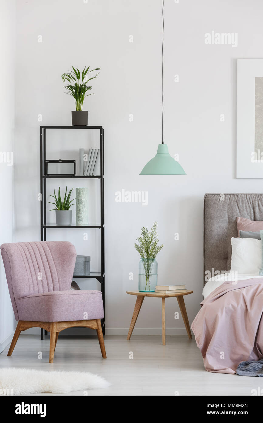 Black Metal Rack With Potted Plants And Books Standing In The Bedroom Corner Stock Photo Alamy