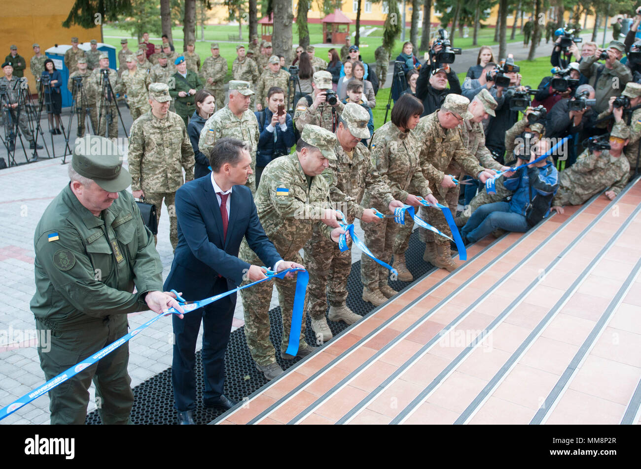 General of the Army of Ukraine Stepan Poltorak, Minister of Defense of Ukraine, (third from left) helps cut a ceremonial ribbon officially opening the new simulation center during Rapid Trident 2017 at the Yavoriv Combat Training Center on the International Peacekeeping and Security Center, on Sept. 15. (Photo by Capt. Kayla Christopher, 45th Infantry Brigade Combat Team) Stock Photo