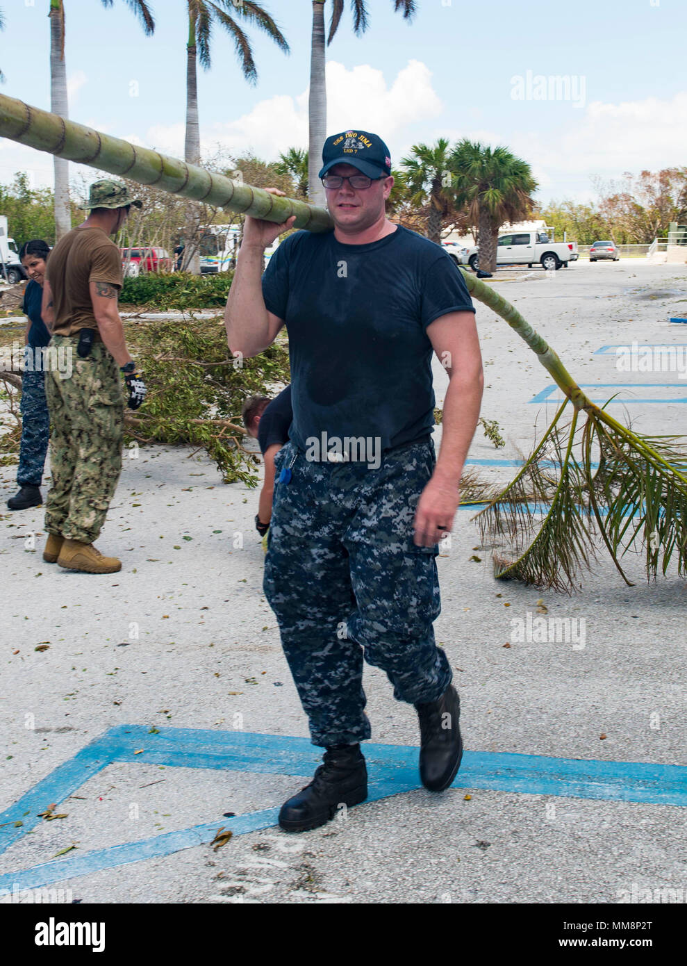 KEY WEST, Fla. (Sept. 14, 2017) Air Traffic Controller 3rd Class Thomas Goss, from New Hampshire, clears debris from Lower Keys Medical Center, Key West, Florida, during humanitarian relief efforts following Hurricane Irma’s landfall in Key West. The Department of Defense is supporting Federal Emergency Management Agency, the lead federal agency, in helping those affected by Hurricane Irma to minimize suffering and as one component of the overall whole-of-government response efforts.  (U.S. Navy photo by Mass Communication Specialist 3rd Class Kevin Leitner/Released) Stock Photo