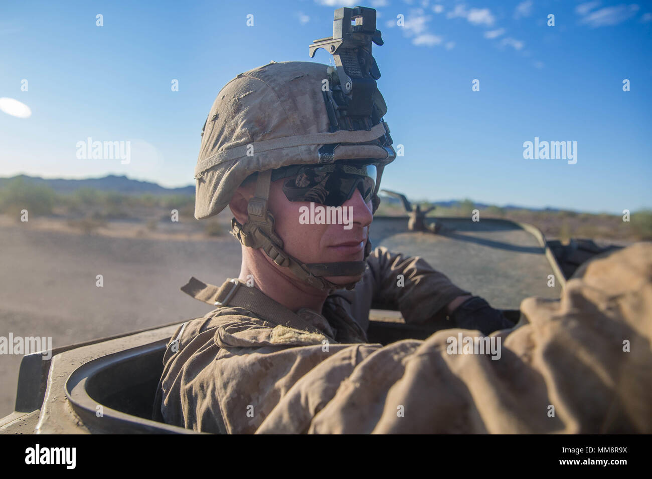U.S. Marine Corps Cpl. Samuel Cappadona, a light armored vehicle (LAV) technician with 1st Light Armored Reconnaissance (LAR) Battalion, 1st Marine Division, stands inside an LAV during exercise Deep Strike II at River Valley, Calif., Sept. 13, 2017. Deep Strike II consisted of 1st LAR conducting long range maneuvers to simulate real world scenarios outside of the normal training area of Marine Corps Base Camp Pendleton. (U.S. Marine Corps photo by Lance Cpl. Roxanna Gonzalez) Stock Photo