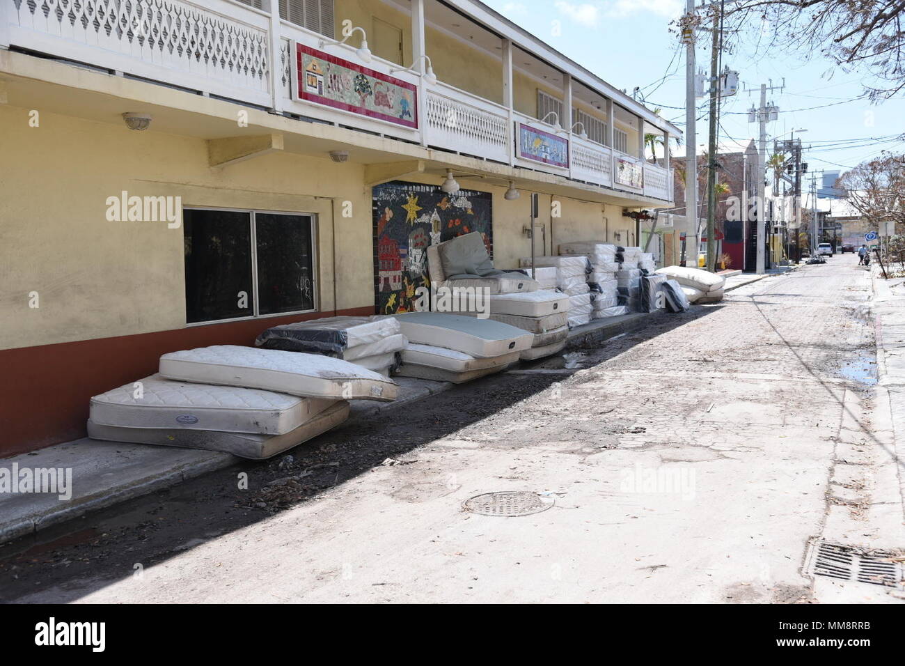 Ruined mattresses line a street Key West, Florida, across from a hotel