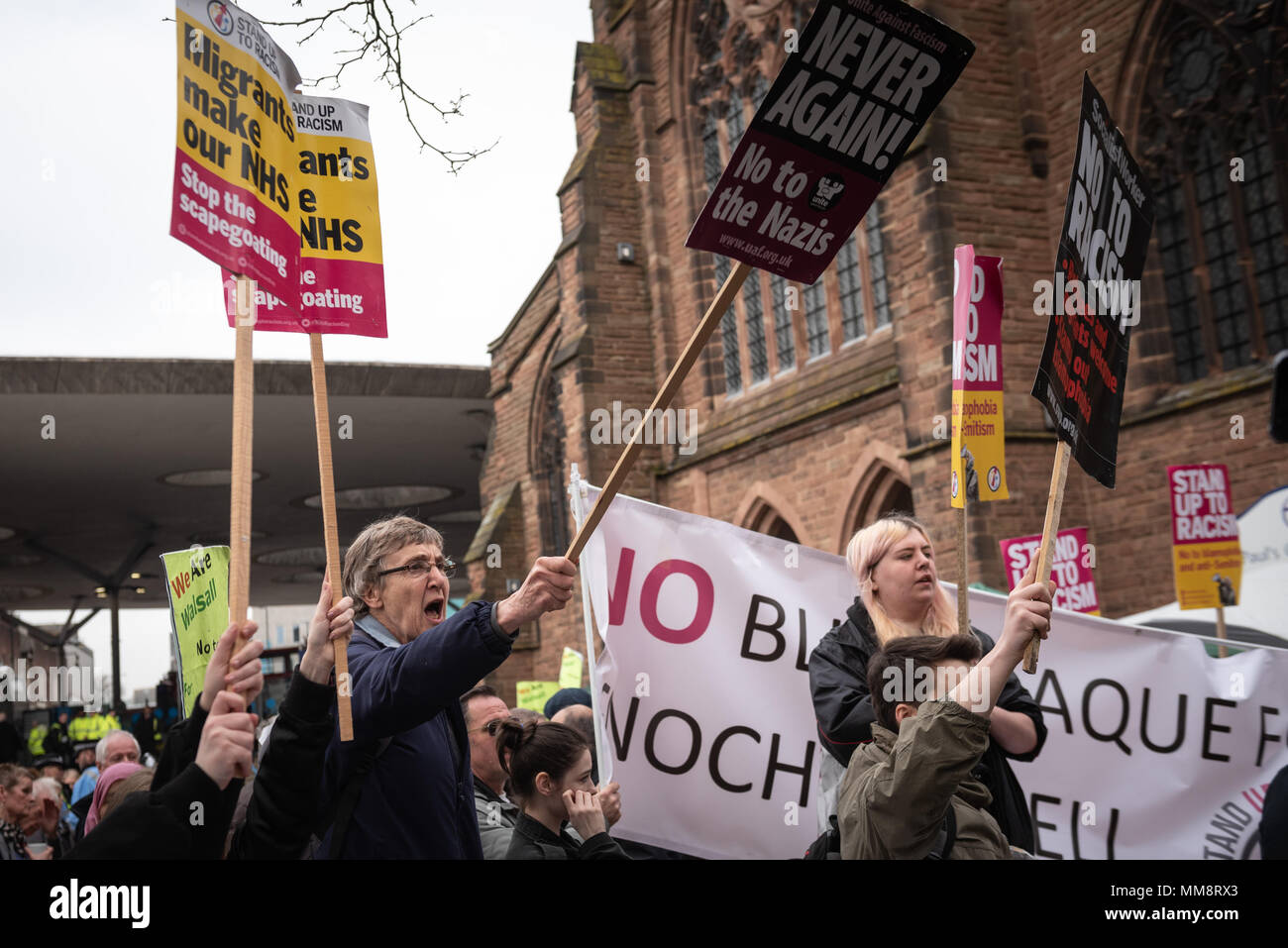 Walsall, West Midlands, UK. 7th April 2018. Pictured: Anti-fascist supporters chant back at EDL members.  / Up to 60 English Defence League supporters Stock Photo
