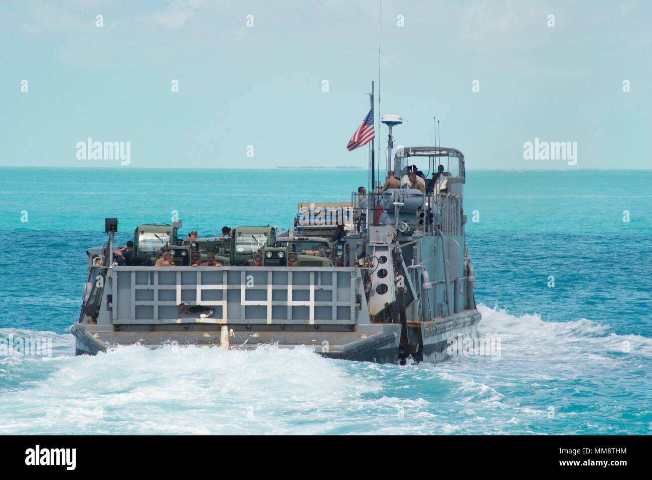 170913-N-DS065-0088 KEY WEST, Fla. (Sept. 13, 2017) A Landing Craft Unit, attached to Assault Craft Unit (ACU) 2, heads to shore in Key West, Fla., with Sailors from the amphibious assault ship USS Iwo Jima (LHD 7) and supplies slated for use in humanitarian assistance efforts following Hurricane Irma’s landfall in Key West. The Department of Defense is supporting Federal Emergency Management Agency, the lead agency, in helping those affixed by Hurricane Irma to minimize suffering and as one component of the overall whole-of-government response efforts. (U.S. Navy photo by Mass Communication S Stock Photo