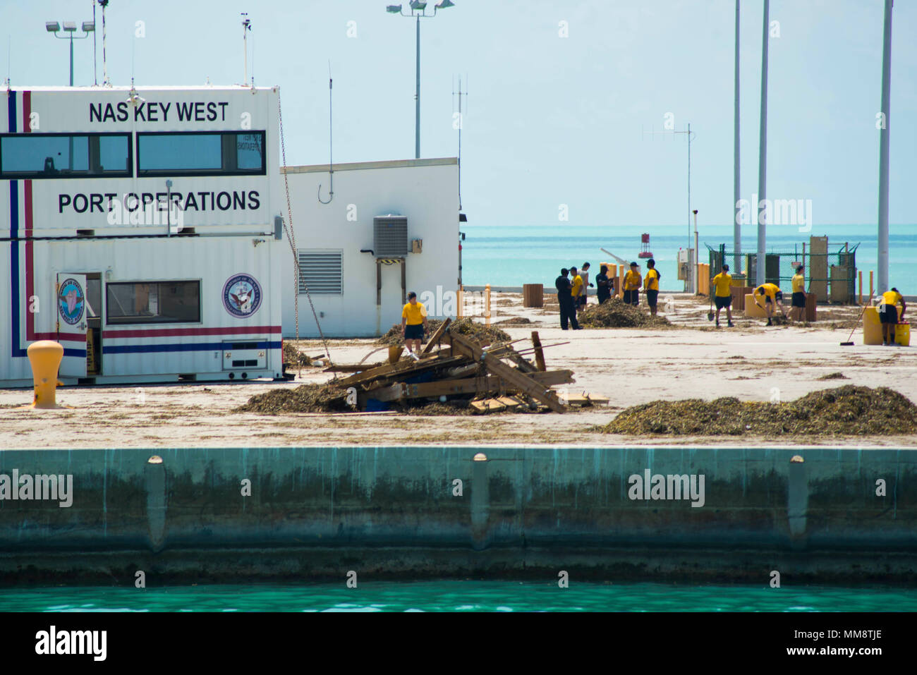 170913-N-DS065-0129 KEY WEST, Fla. (Sept. 13, 2017) Sailors clean the pier at Naval Air Station Key West, Fla., during humanitarian assistance efforts following Hurricane Irma’s landfall in Key West. The Department of Defense is supporting Federal Emergency Management Agency, the lead agency, in helping those affixed by Hurricane Irma to minimize suffering and as one component of the overall whole-of-government response efforts. (U.S. Navy photo by Mass Communication Specialist 3rd Class Evan A. Denny/Released) Stock Photo