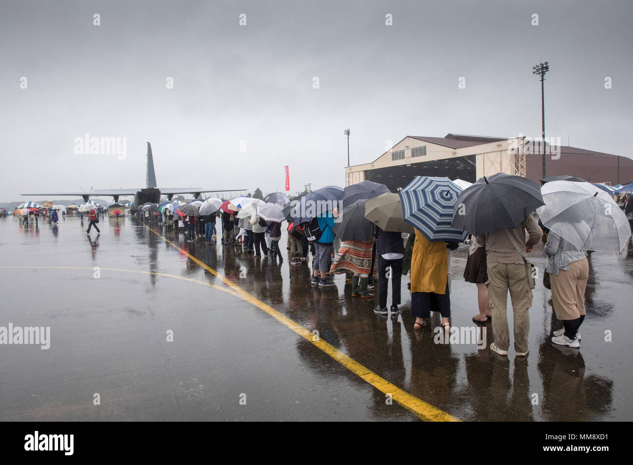 Spectators wait in line to enter a C-130J Super Hercules during the 2017 Japanese-American Friendship Festival at Yokota Air Base, Japan, Sept. 17, 2017. This is the first time that Yokota's new C-130J was displayed during the festival. (U.S. Air Force photo by Yasuo Osakabe) Stock Photo