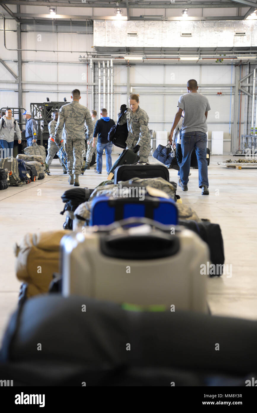 Airmen pick up their luggage after their arrival to Fairford Royal Air Force Base, Sept. 11, 2017. U.S. Strategic Command bomber forces regularly conduct combined theater security cooperation engagements with allies and partners, demonstrating the U.S. capability to command, control and conduct bomber missions across the globe. Bomber missions demonstrate the credibility and flexibility of the military's forces to address today's complex, dynamic and volatile global secruty environment. (U.S. Air Force photo/Staff Sgt. Benjamin Raughton) Stock Photo