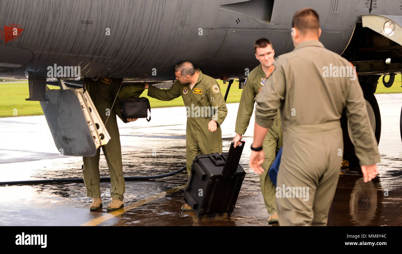 Aircrew retrieve their equipment from a B-52 Stratofortress upon arrival at Fairford Royal Air Force Base, U.K., Sept. 14, 2017. The B-52 is scheduled to conduct theater integration, flying training, and joint and allied training to improve bomber interoperability. Allied training will also include participation in exercise SERPENTEX, a French Air Command-led exercise that will focus on training aircrew and JTACs in their Air Land integration mission. (U.S. Air Force photo/Staff Sgt. Benjamin Raughton) Stock Photo