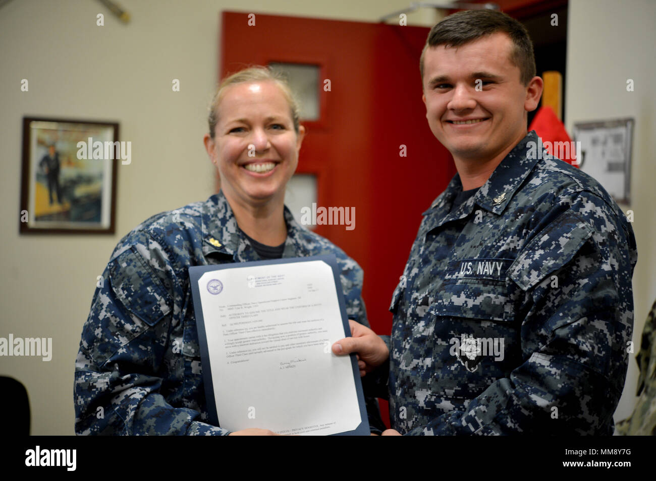 (September 16, 2017) SAGINAW, Mich. - Machinist Mate 3rd Class Tyler R. Wright is frocked by Lt. Cdr. Amy J. Minkin, Commanding Officer Navy Operational Support Center Saginaw. Minkin, a Midland, Mich. native, replaced the offgoing commander officer in August 2017.  (U.S. Navy photo Mass Communication Specialist 1st Class Jenny L. Lasko) Stock Photo