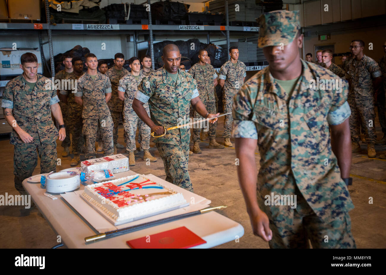 Lt. Col. Harold E. Dowling, Marine Tactical Air Command Squadron 18 commanding officer, prepares to cut the cake during the 50th anniversary celebration of MTACS-18 at Marine Corps Air Station Futenma, September 15, 2017. During the ceremony, Marines read excerpts about the courageous efforts put forth by MTACS-18. The squadron was activated on September 1, 1967 at Da Nang, Republic of Vietnam, as Headquarters and Headquarters Squadron 18, Marine Air Control Group 18, 1st Marine Aircraft Wing. (U.S. Marine Corps photo by Lance Cpl. Andy Martinez) Stock Photo