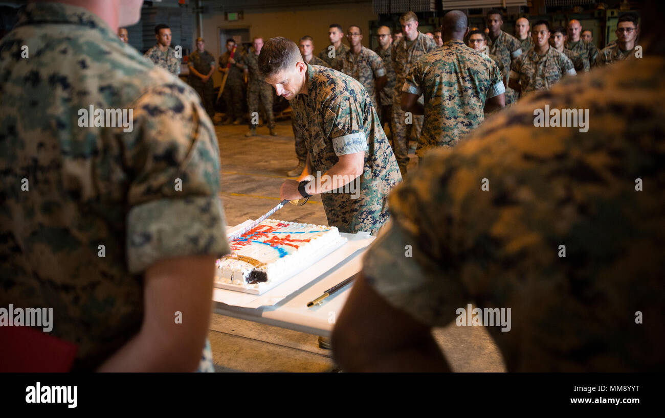 Sgt. Maj. Jeffrey D. Durham, Marine Tactical Air Command Squadron 18 sergeant major, cuts the cake during the 50th anniversary celebration of MTACS-18 at Marine Corps Air Station Futenma, September 15, 2017. During the ceremony, Marines read excerpts about the courageous efforts put forth by MTACS-18. The squadron was activated on September 1, 1967 at Da Nang, Republic of Vietnam, as Headquarters and Headquarters Squadron 18, Marine Air Control Group 18, 1st Marine Aircraft Wing. (U.S. Marine Corps photo by Lance Cpl. Andy Martinez) Stock Photo