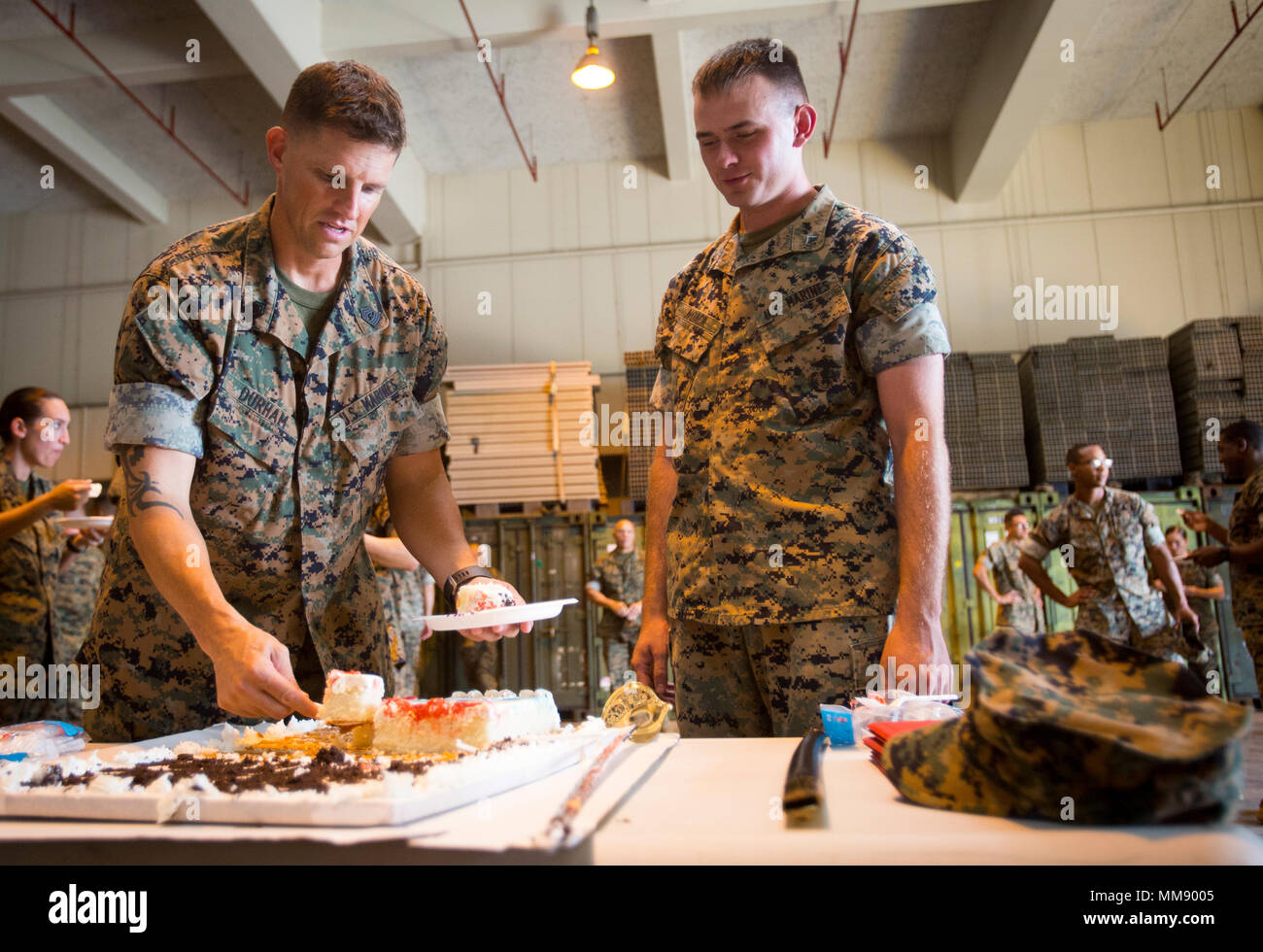Sgt. Maj. Jeffrey D. Durham, Marine Tactical Air Command Squadron 18 sergeant major, passes out slices of cake during the 50th anniversary celebration of MTACS-18 at Marine Corps Air Station Futenma, September 15, 2017. During the ceremony, Marines read excerpts about the courageous efforts put forth by MTACS-18. The squadron was activated on September 1, 1967 at Da Nang, Republic of Vietnam, as Headquarters and Headquarters Squadron 18, Marine Air Control Group 18, 1st Marine Aircraft Wing. (U.S. Marine Corps photo by Lance Cpl. Andy Martinez) Stock Photo