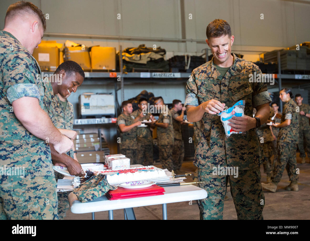Sgt. Maj. Jeffrey D. Durham, Marine Tactical Air Command Squadron 18 sergeant major, opens a bag of utensils during the 50th anniversary celebration of MTACS-18 at Marine Corps Air Station Futenma, September 15, 2017. During the ceremony, Marines read excerpts about the courageous efforts put forth by MTACS-18. The squadron was activated on September 1, 1967 at Da Nang, Republic of Vietnam, as Headquarters and Headquarters Squadron 18, Marine Air Control Group 18, 1st Marine Aircraft Wing. (U.S. Marine Corps photo by Lance Cpl. Andy Martinez) Stock Photo