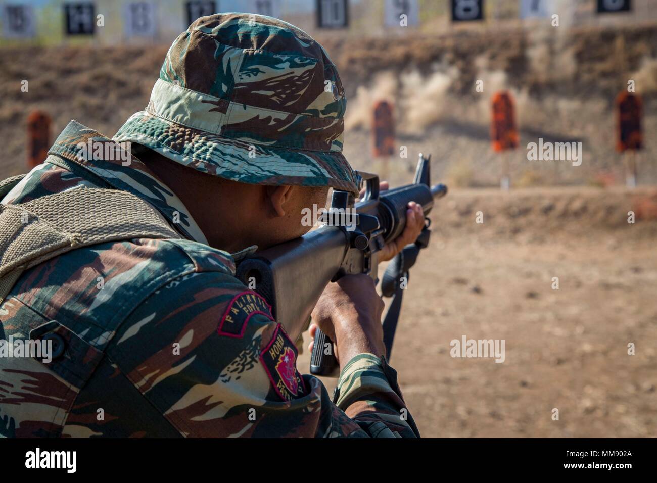 A member of the Falantil Forca de Defensa Timor Leste shoots at a target at a live fire range during Exercise Crocodilo as a part of Exercise Koa Moana 17 in Metinaro, Timor Leste, Sept. 11, 2017. Koa Moana 17 is designed to improve interoperability with our partners, enhance military-to-military relations, and expose the Marine Corps forces to different types of terrain for familiarity in the event of a natural disaster in the region.   (U.S. Marine Corps photo by MCIPAC Combat Camera Lance Cpl. Juan C. Bustos) Stock Photo