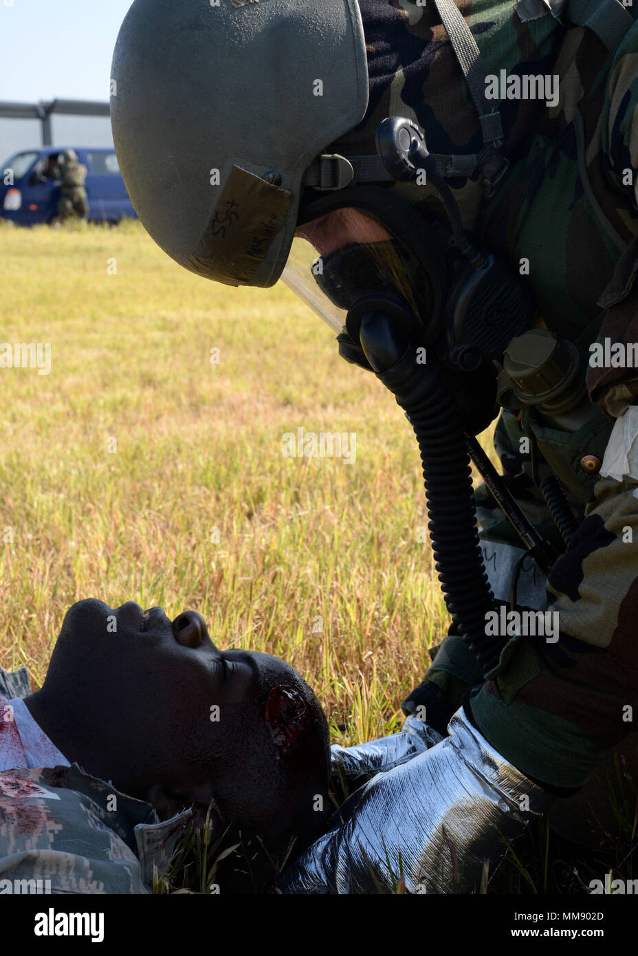 Staff Sgt. Brian McKinley, right, 51st Civil Engineer Squadron fire department crew chief, holds the cervical spine of Staff Sgt. Dennis Middleton, 51st Communication Squadron project manager, during a mass casualty scenario of exercise Beverly Herd 17-3 at Osan Air Base, Republic of Korea September 18, 2017. As part of the First Response Team, McKinley arrived before medical personnel and administered first-aid to injured victims. (U.S. Air Force photo by Tech Sgt. Ashley Tyler/Released) Stock Photo