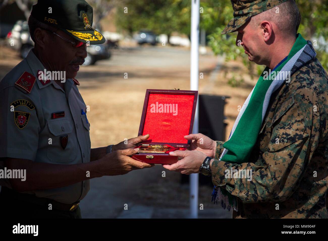 U.S. Marine Corps Maj. Brian Hollier, right, task force commander for Task Force Koa Moana 17, receives a plaque during a closing ceremony for Exercise Crocodilo in Metinaro, Timor Leste, Sept. 14, 2017. Koa Moana 17 is designed to improve interoperability with our partners, enhance military-to-military relations, and expose the Marine Corps forces to different types of terrain for familiarity in the event of a natural disaster in the region.  (U.S. Marine Corps photo by MCIPAC Combat Camera Lance Cpl. Juan C. Bustos) Stock Photo