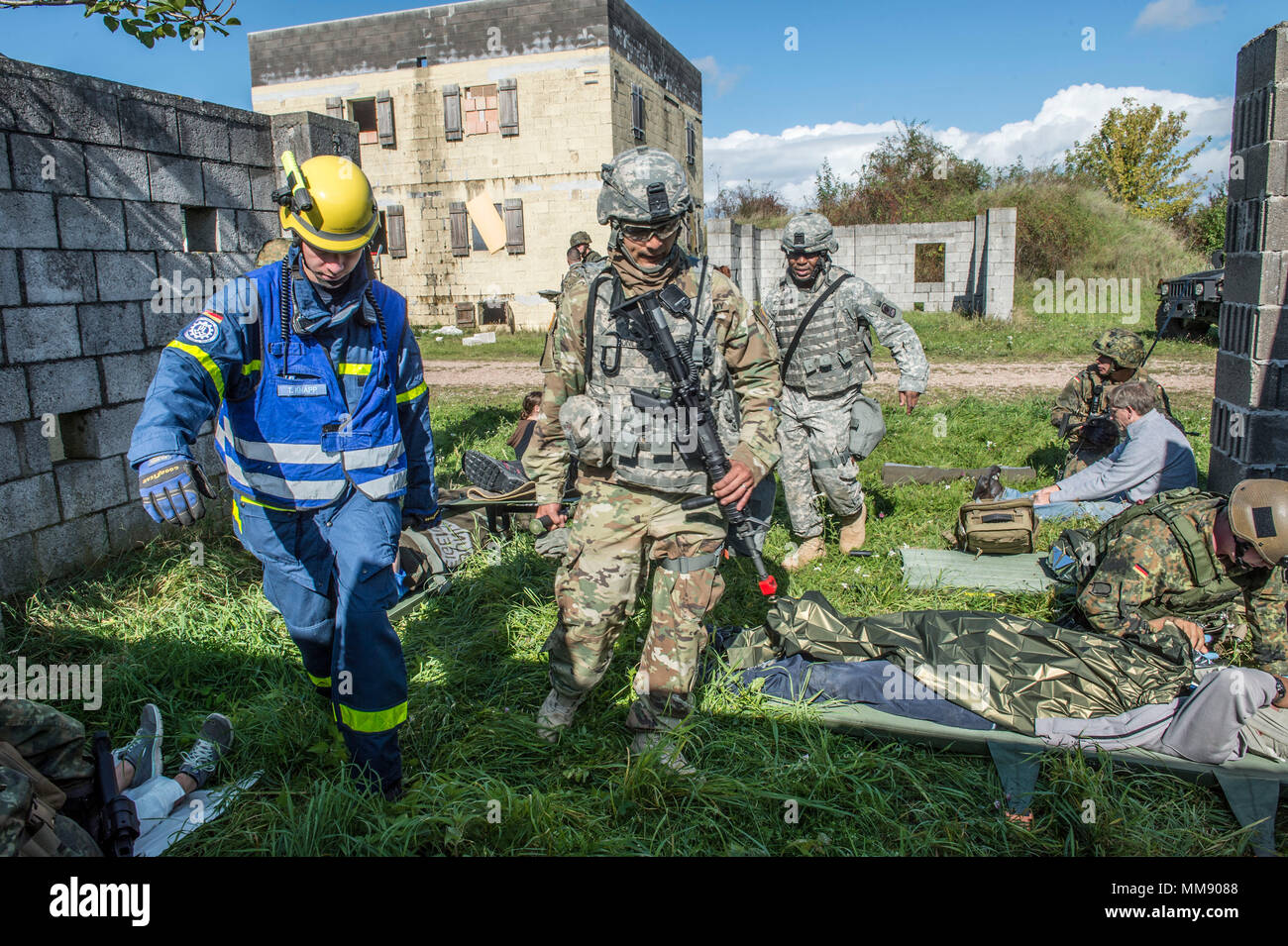 U.S. Soldiers assigned to C Co. 457th Civil Affairs Battailon, Members of the American Red Cross, Technisches Hilfswerk Frankenthal & Bad Kreuznach (Germany) and German Bundeswehr Soldiers assigned to Sanitaets Staffel Einsatz Koeln-Wahn conduct Cobra Strike 17, a Multi-National Disaster Response Training, led by C Co. 457th Civil Affairs Battalion at the Urban Operations Training Site located in Wackernheim, Germany, Sept. 16, 2017. Stock Photo