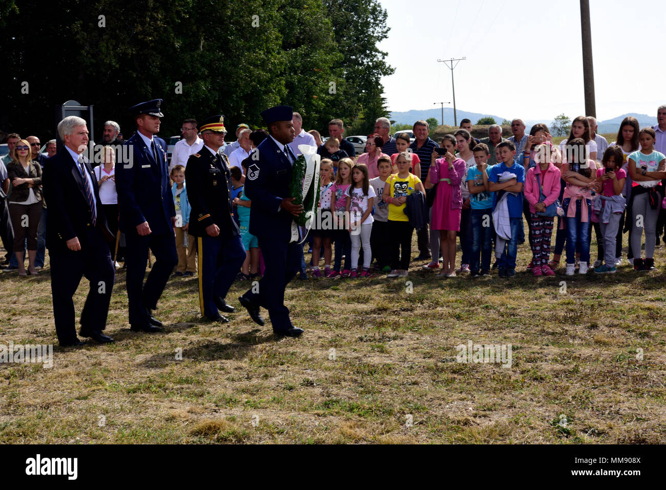 Distinguished visitors from the U.S. Embassy in Serbia and the Ohio Air National Guard present a wreath to commemorate the 73rd anniversary of Operation Halyard at Galobica Field in Pranjani, Serbia, Sept. 16, 2017. From August 1944 to February 1945, with the help of the local Serbian citizens and the former Yugoslav Armed Forces in the Homeland, more than 500 airmen were transported from improvised runways in Serbia to U.S. airbases in Italy. (U.S. Air Force photo by Staff Sgt. Rachelle Coleman) Stock Photo
