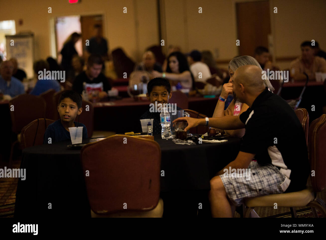 U.S. Marines and Sailors stationed at Marine Corps Air Station Yuma, Ariz., gather at the Sonoran Pueblo on Sept. 16, 2017, to watch the Canelo Alvarez and Gennady Golovkin boxing match. Marine Corps Community Services planned the event for Marines, Sailors and their families to watch and enjoy together. (U.S. Marine Corps photo taken by Lance Cpl. Sabrina Candiaflores) Stock Photo