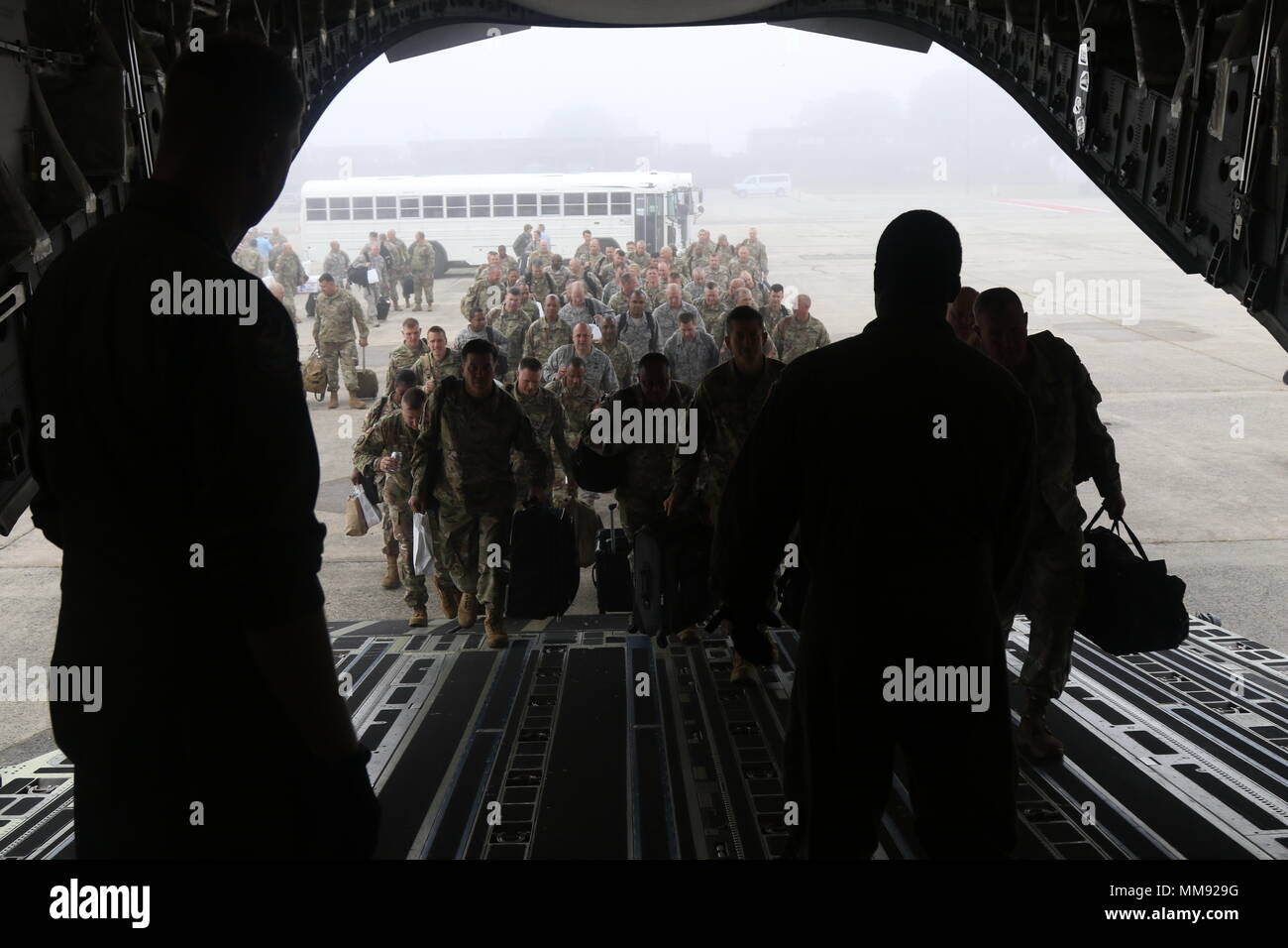 Soldiers and Airmen of the Mississippi National Guard board a cargo plane as they leave Hanscom Air Force Base to finish up the annual staff ride, September 17, 2017, in Massachusetts. The Mississippi National Guard Senior Leader Staff Ride allowed officers and senior enlisted to bond with one another while learning about the history of the minuteman and the Revolutionary War. (Mississippi National Guard photo by Cpl. Justin Humphreys, 102d Public Affairs Detachment) Stock Photo