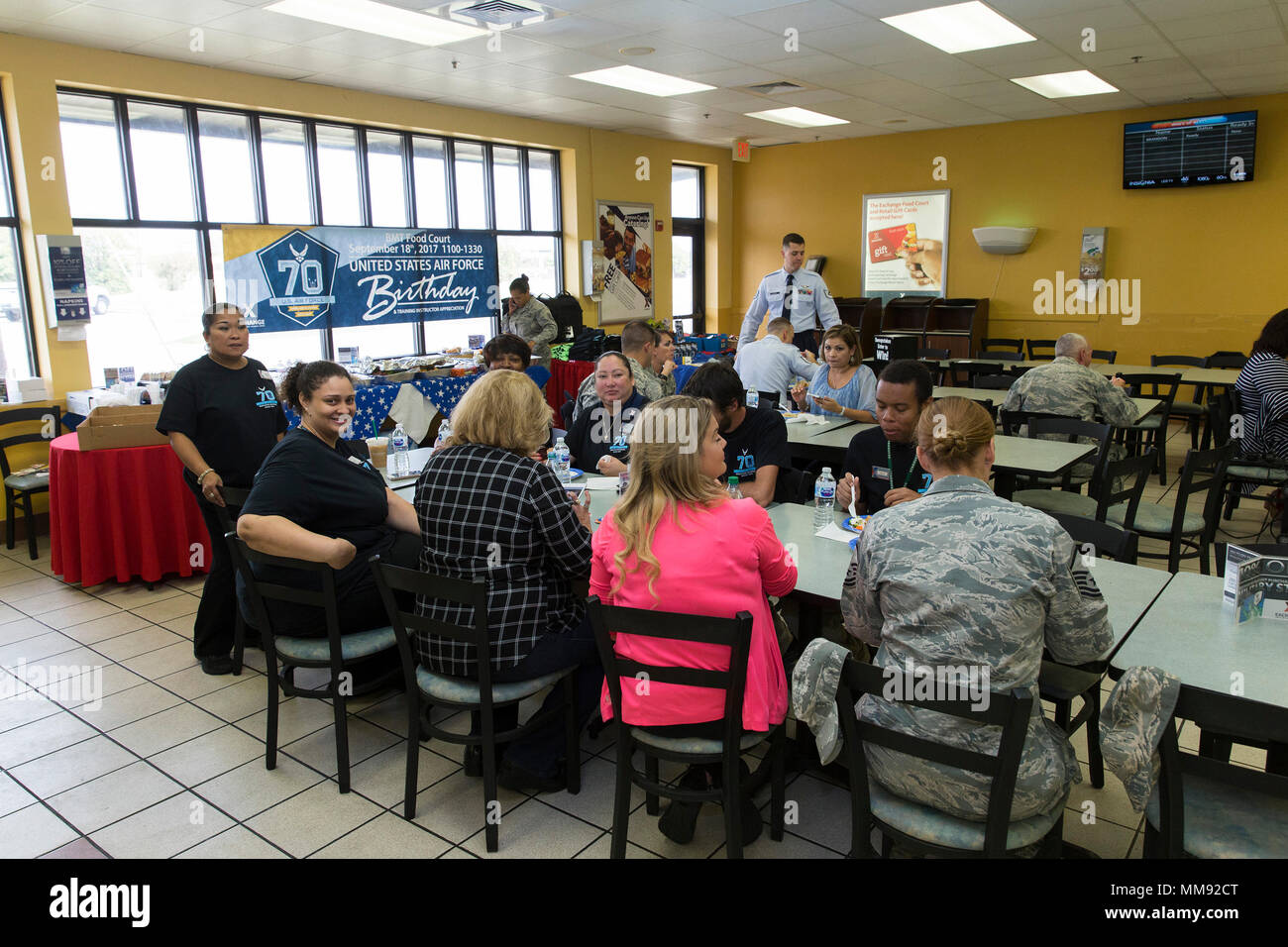 The basic military training mini mall troop store for prospective airmen held a luncheon for training instructors on Joint Base San Antonio-Lackland to recognizes their efforts and to commemorate the 70th Birthday of the U.S. Air Force Sept. 18, 2017. The luncheon was organized by Pamela Brown, BMT PX store manager, and Marvie Riouax, BMT PX assistant store manager, and featured food and music for some of the TIs that work in the area. The facility provides services for over 200 TI a day. (U.S. Air Force by Ismael Ortega.) Stock Photo