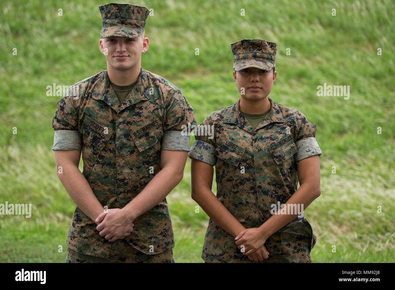 CAMP FOSTER, OKINAWA, Japan – Cpl. Jody Scott, left, and Cpl. Sara Lopez, right, pose for a picture Sept. 14 aboard Camp Foster, Okinawa, Japan. Lopez came looking for Scott to help her earn a 300 CFT and her next Marine Corps Martial Arts Program belt. Scott teaches two to three separate MCMAP classes a month working around other Marine’s schedules, despite the toll that it takes on his own battered body. Scott focuses on his Marines, like Lopez, treating all ranks equally and ensuring that each of their personal goals are met. Scott is a Marine Corps Martial Arts Instructor with Headquarters Stock Photo