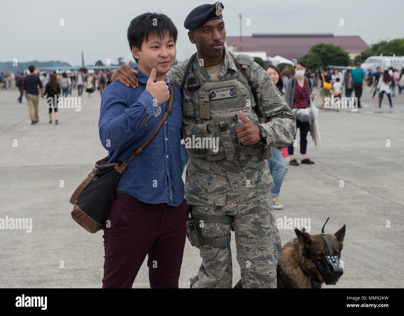 An Airman from the 374th Security Forces Squadron poses with a visitor of  the 2017 Japanese-American Friendship Festival, Sept. 16, 2017 at Yokota  Air Base, Japan. The festival is designed to bolster