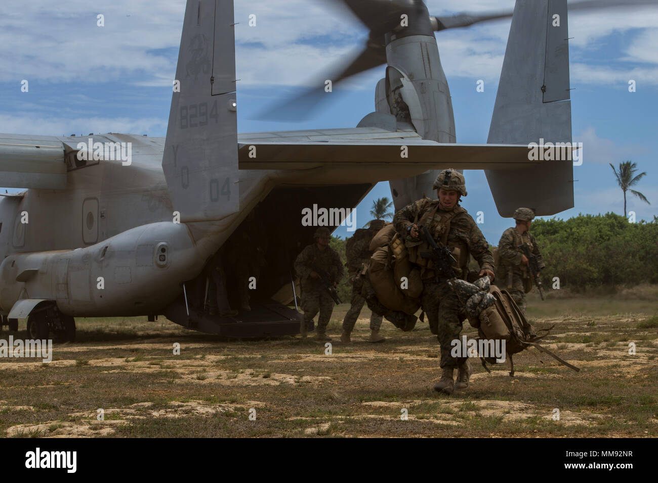 U.S. Marines with 3rd Battalion, 3rd Marine Regiment, unload gear from a MV-22B Ospery with Marine Medium Tiltrotor Squadron 268, 1st Marine Aircraft Wing, after returning to Marine Corps Air Station Kaneohe Bay during the conclusion of Exercise Bougainville II, Sept. 15, 2017. Bougainville II was conducted in the Pohakuloa Training Area, Hawaii, to train Marines in the Regiment on how to operate as a ground combat element of the Marine Air-Ground Task Force. (U.S. Marine Corps Photo by: Sgt. Alex Kouns) Stock Photo