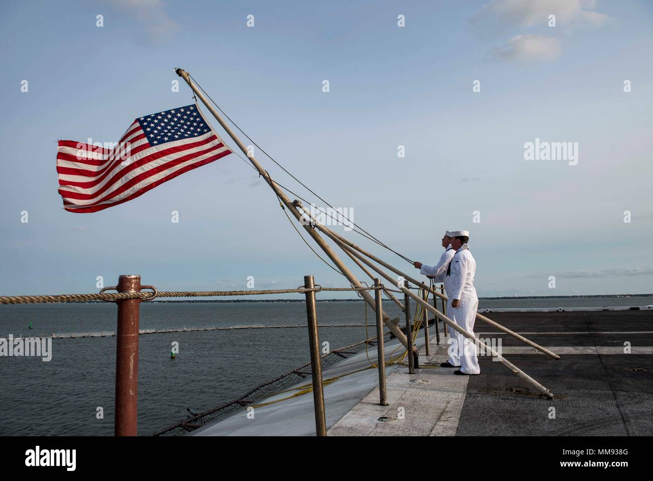 170911-N-AJ467-044 NORFOLK (Sept. 11, 2017) Sailors raise the American flag  for morning colors on Sept. 11 aboard the aircraft carrier USS George H.W.  Bush (CVN 77). The ship is in port in